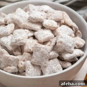 Cinnamon puppy chow chex mix in white bowl.