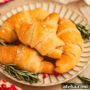 Crescent rolls with sea salt on top on plate.