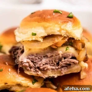 Roast beef slider with cheese, onion and mushrooms.