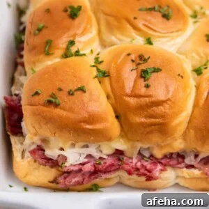 Slow cooker reuben sliders in white pan.