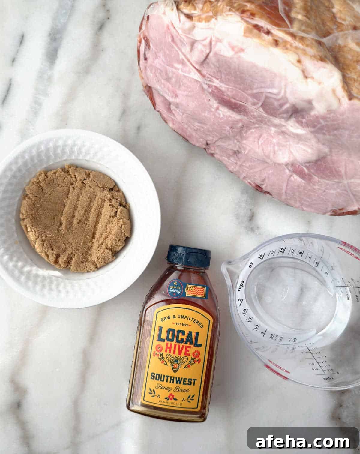 Oven-Baked Ham Slices: Quick Recipe for Perfectly Crispy Edges 4 cooked spiral ham, brown sugar, honey, water.