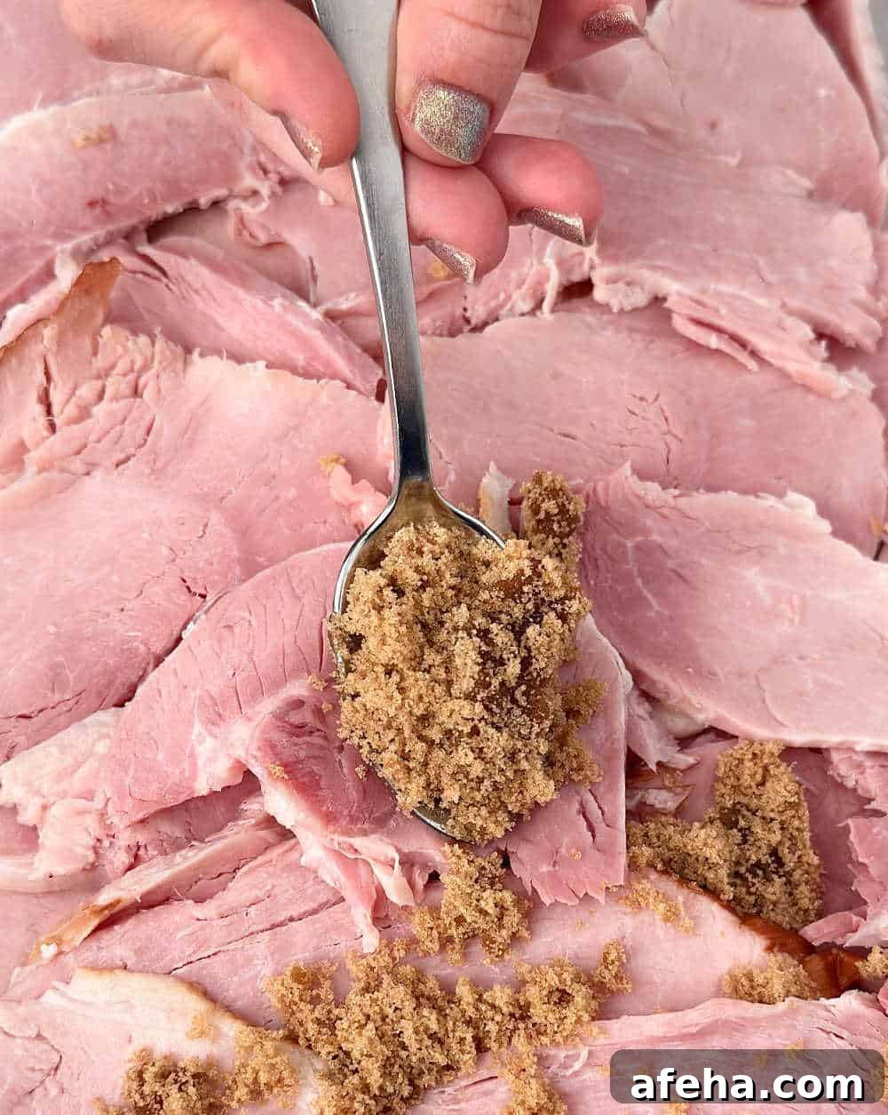 Oven-Baked Ham Slices: Quick Recipe for Perfectly Crispy Edges 6 spooning brown sugar honey mixture over ham.