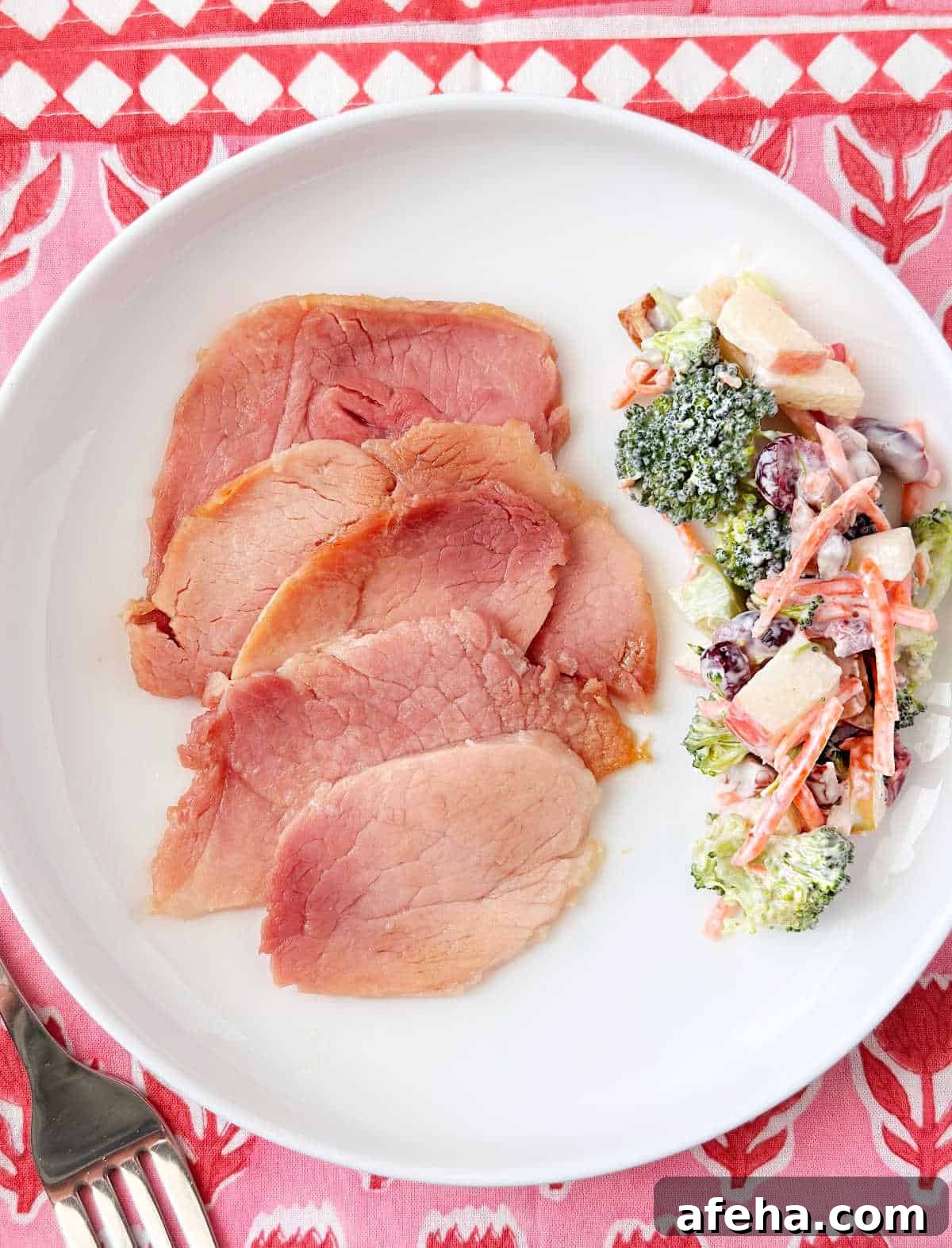 Oven-Baked Ham Slices: Quick Recipe for Perfectly Crispy Edges 9 brown sugar ham with broccoli salad on a plage.