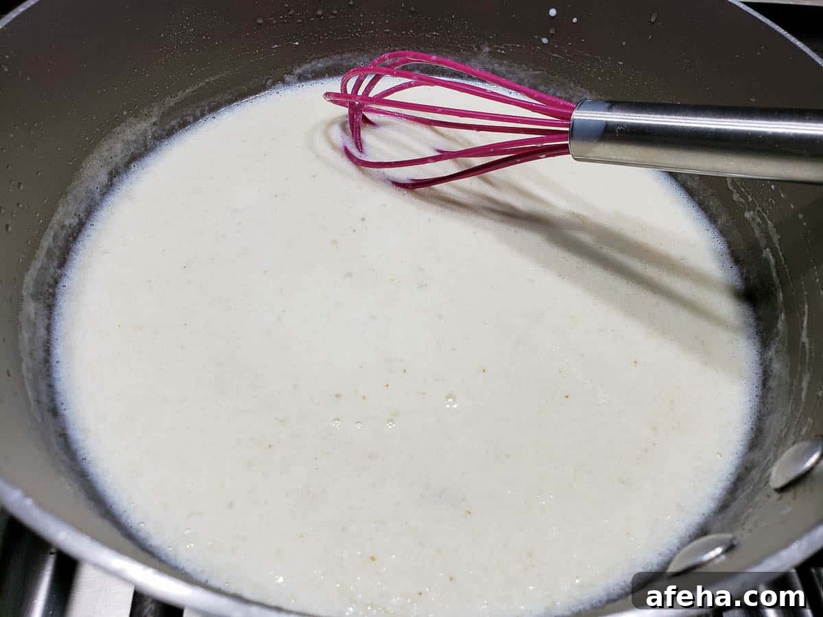 Creamy Cheddar Vegetable Soup Recipe for Cozy Weeknights 8 milk whisked into flour mixture in a pan.