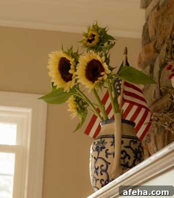 white nite pro cut sunflowers in blue and white pitcher on fireplace mantle
