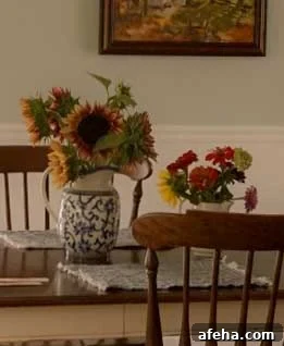 two bouquets on dining room table: one with plum procut sunflowers, one with red and green zinnias