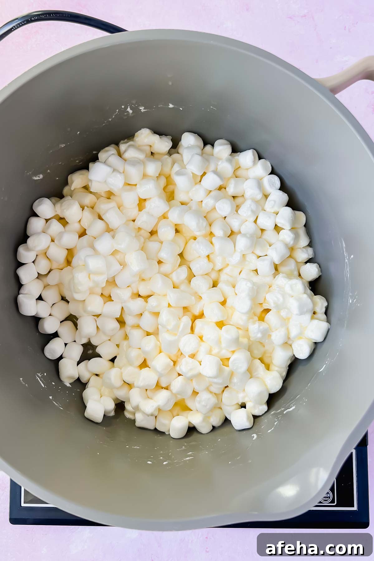 marshmallows melting in gray sauce pot.
