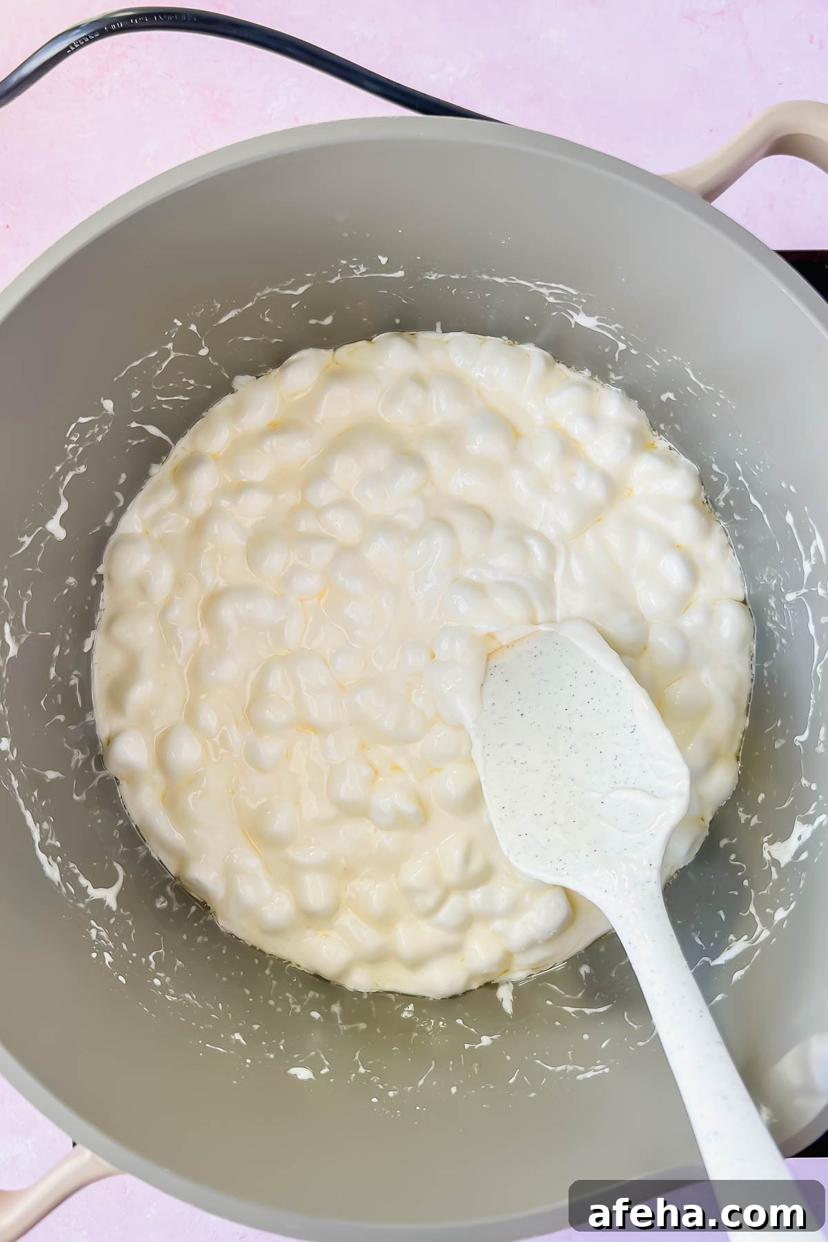 marshmallows melting in gray sauce pot.