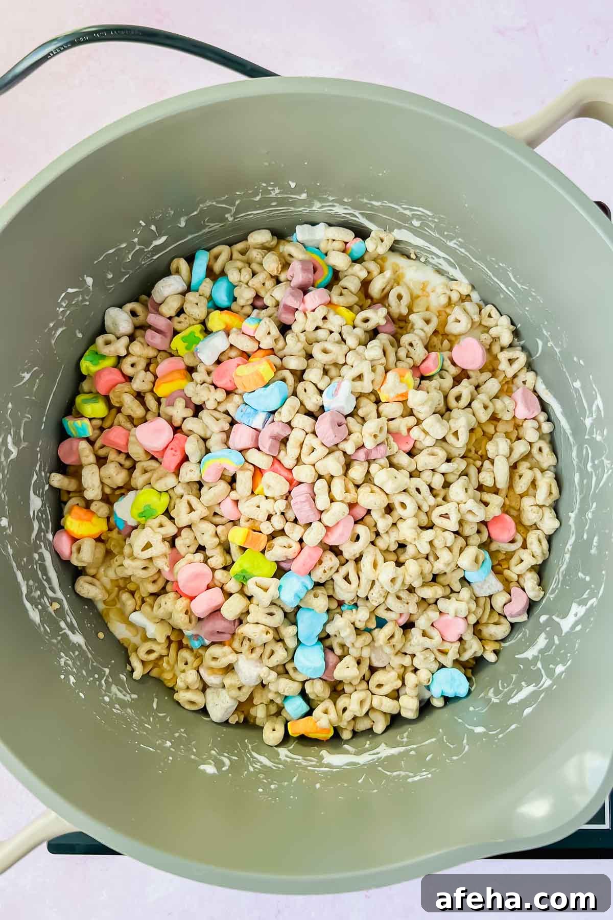 lucky charms in gray sauce pot with melted marshmallows.