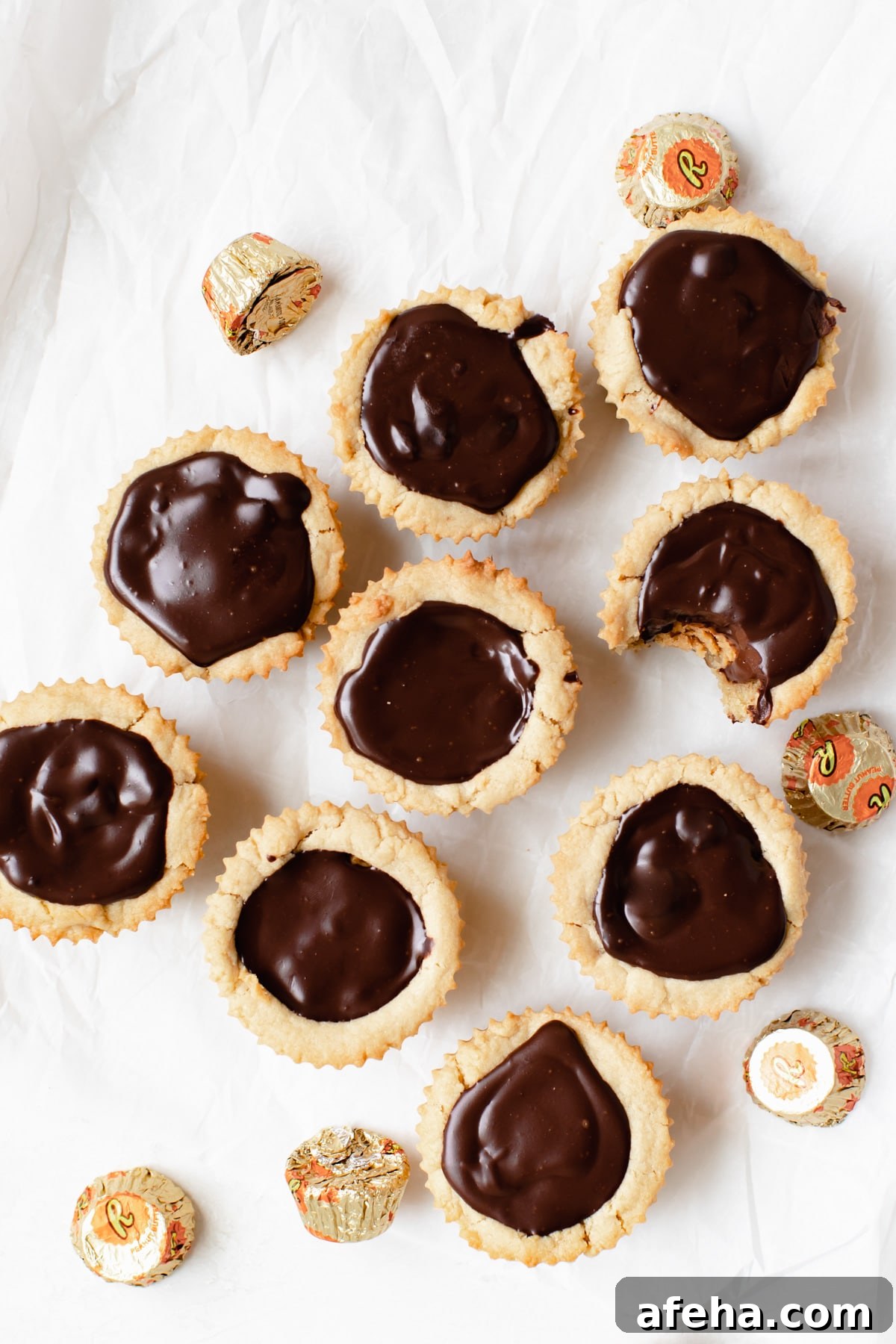 cookies on parchment paper with peanut butter cup candies