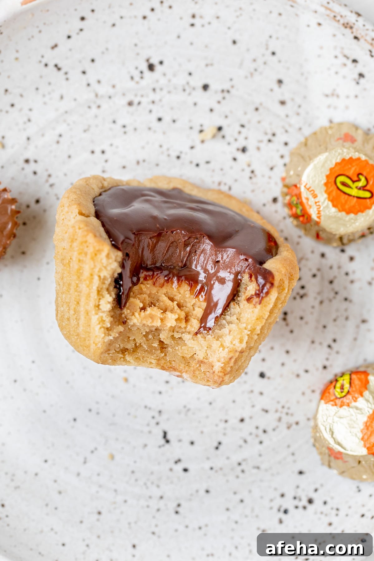 a bite taken out of a peanut butter cup cookie