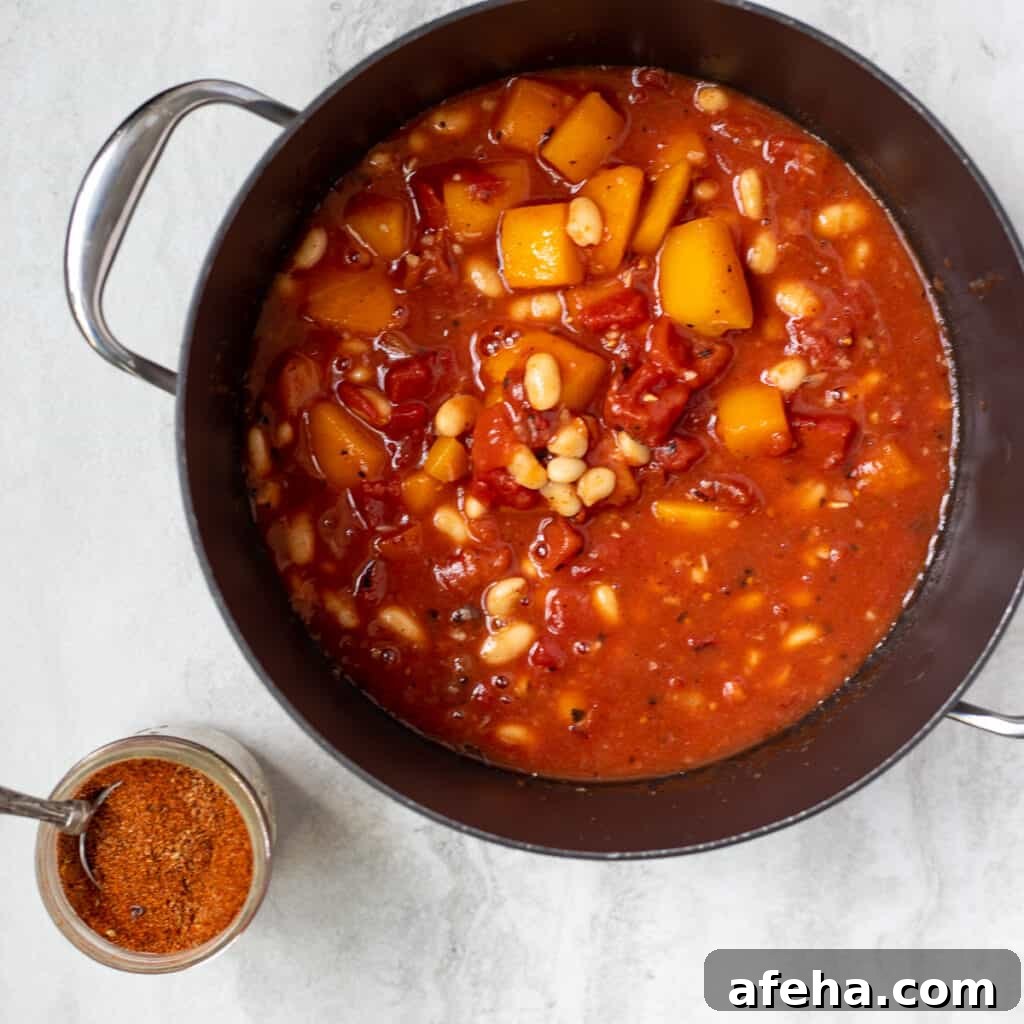 Butternut Squash Chili in dutch oven stockpan next to chili seasoning.
