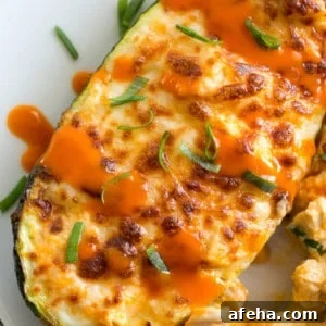 buffalo chicken zucchini boat on white plate