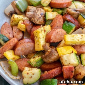 smoked sausage and vegetables on white plate