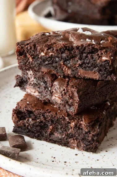 Chick-fil-a brownies with chocolate chunks stacked on top of eachother.