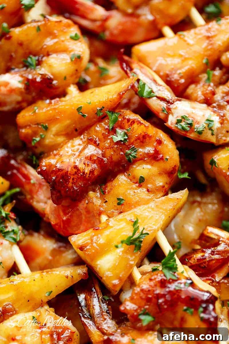 Zoom in image focusing on pineapple pieces from Shrimp Pineapple Skewers cooked in honey garlic butter sauce 