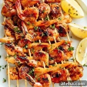 Honey Garlic Butter Shrimp Pineapple Skewers are cooked in the most incredible honey garlic butter sauce on a plater