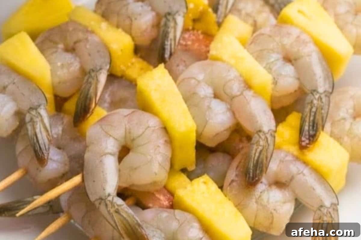 Once soaked, alternate shrimp and pineapple pieces on each skewer