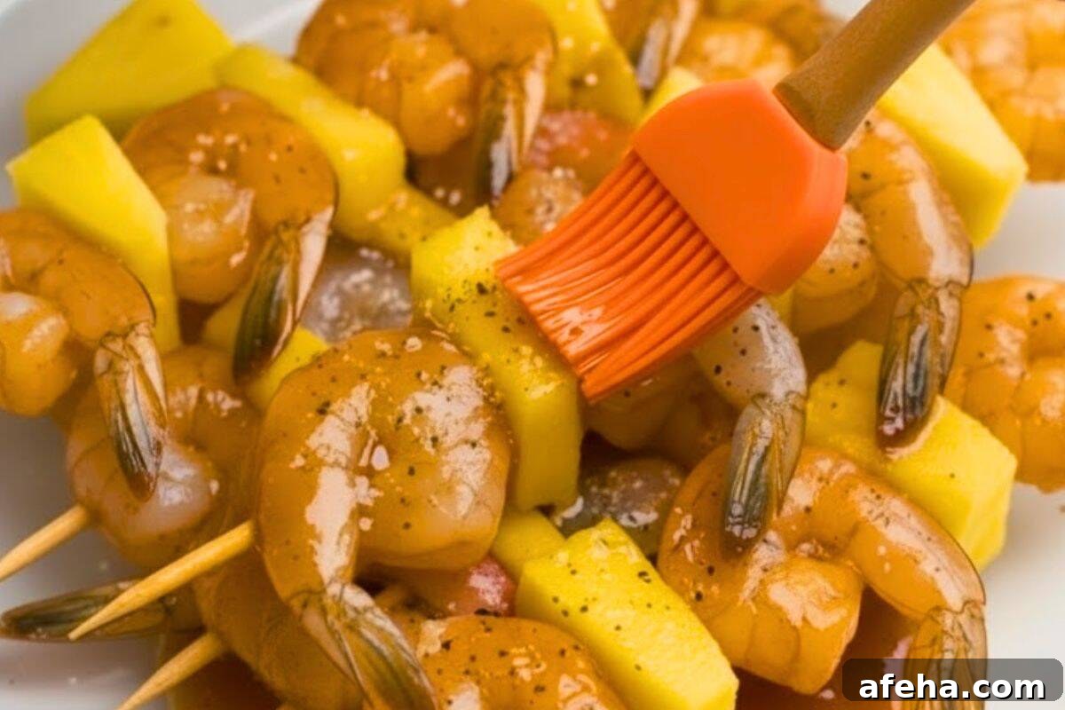 Brush both sides of each skewer with the honey garlic butter sauce until evenly coated and glossy.