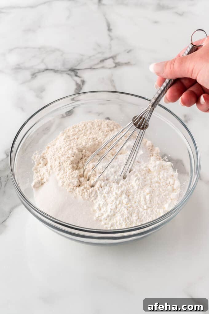 whisking dry ingredients to make crispy waffles