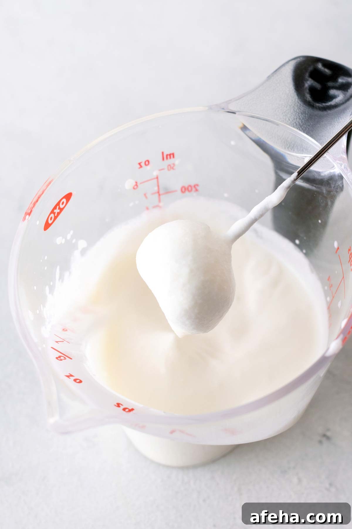 Whipped cream in a measuring cup. 