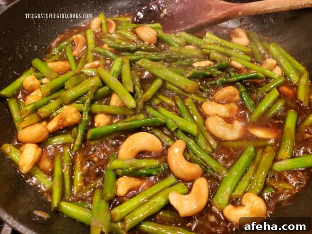 After heating through, the asparagus cashew stir fry is ready to remove from the heat and be served.