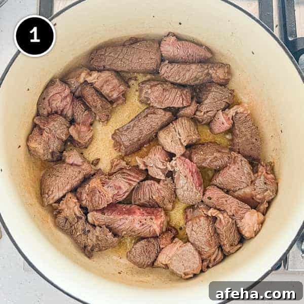 Beef pieces frying in a pan