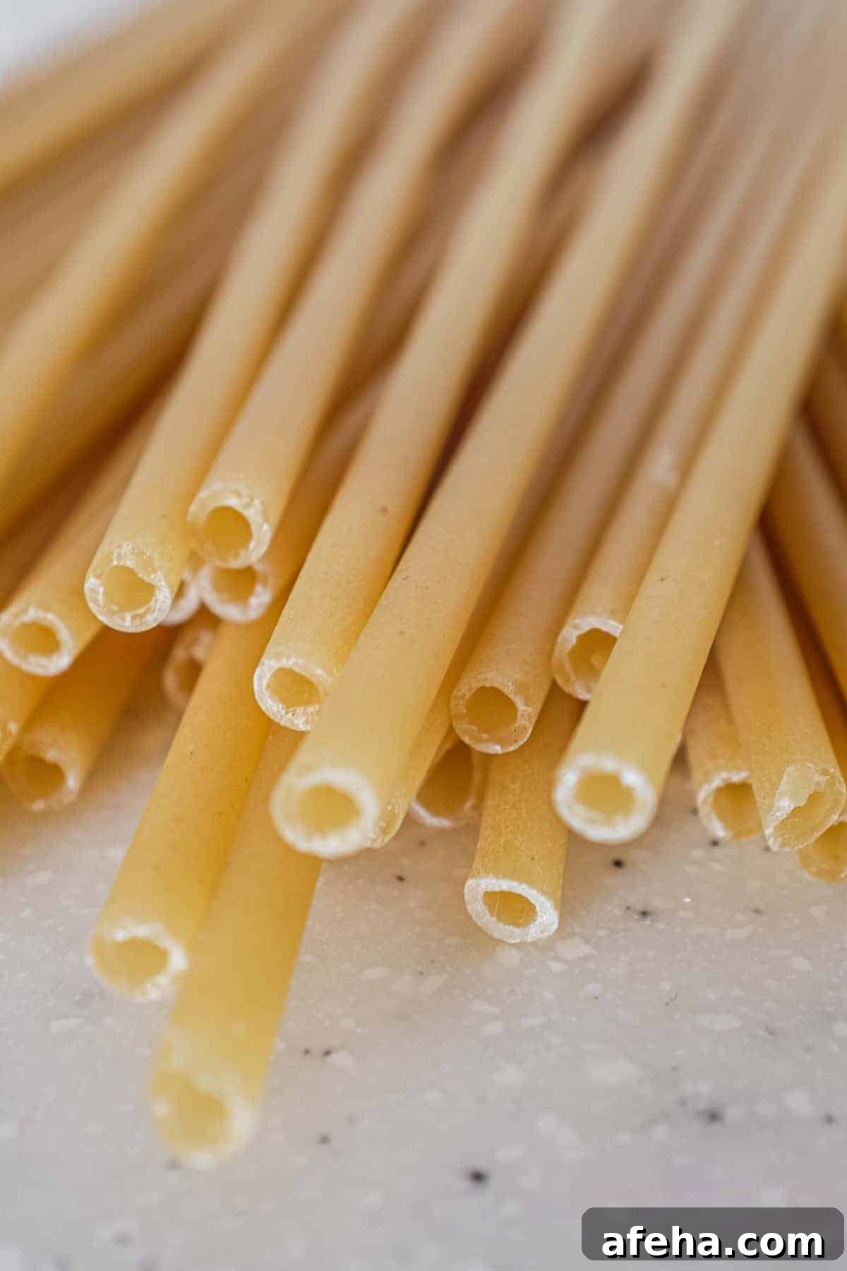 Long tubes of pasta in a pile.