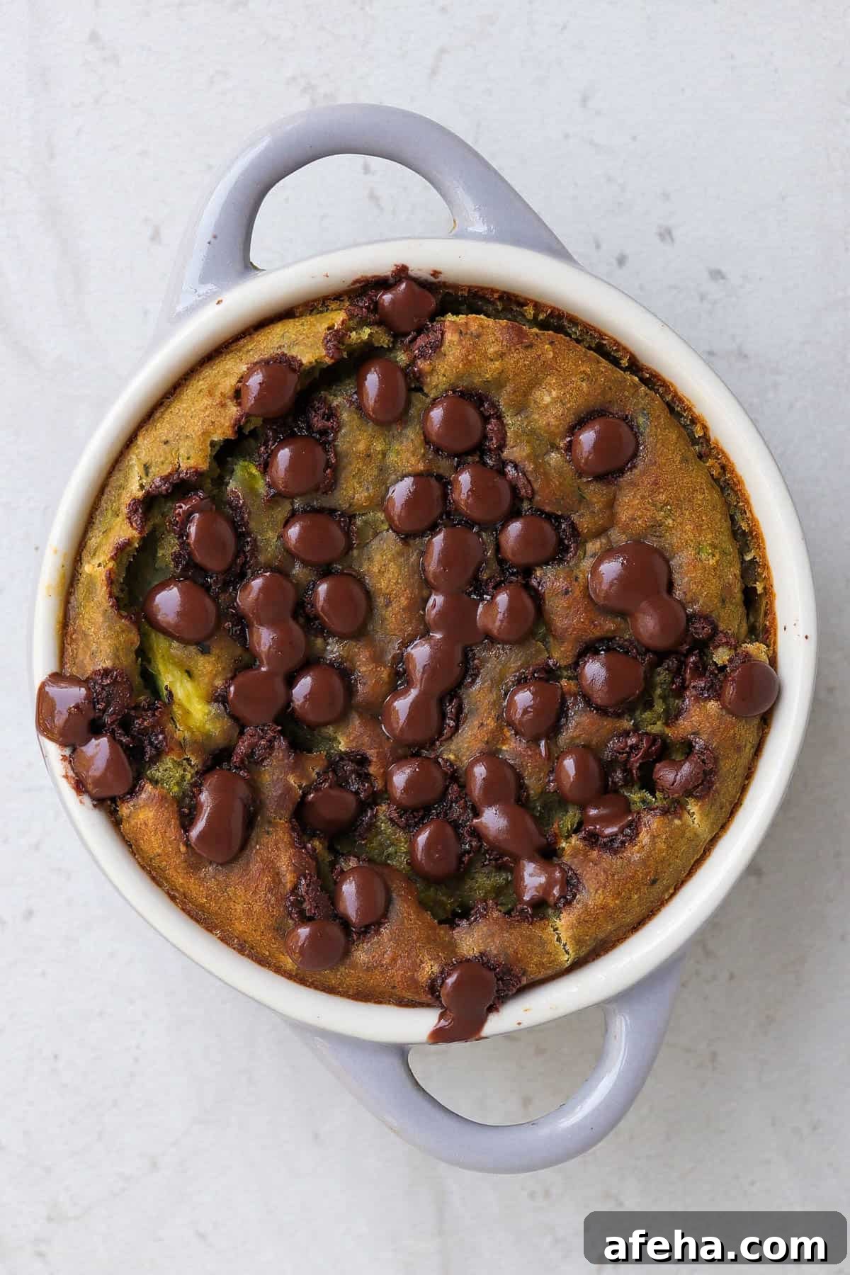 Baked oats in ramekin with melted chocolate chips.