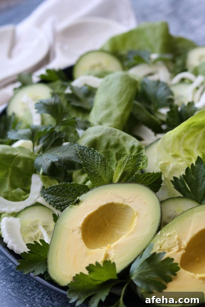 Crisp Butter Lettuce Salad with Lemon Vinaigrette 5 side view of butter lettuce green salad with utensils