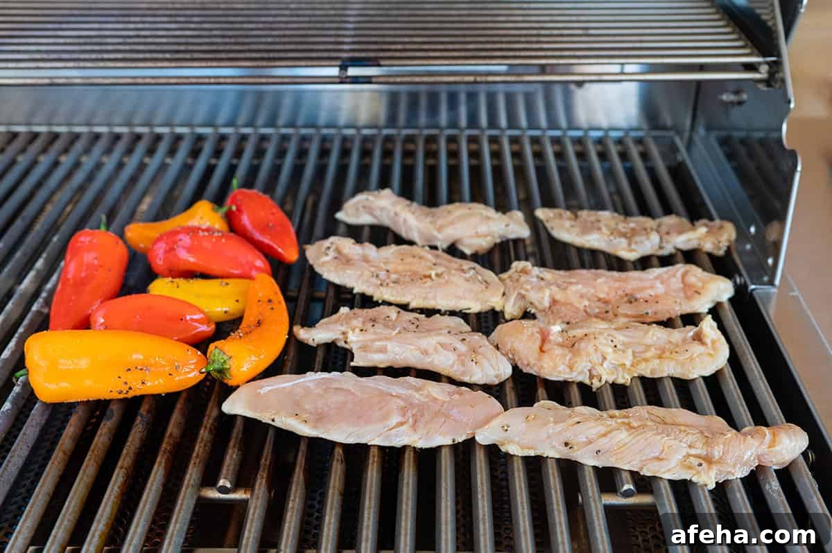 Chicken and peppers on grill.