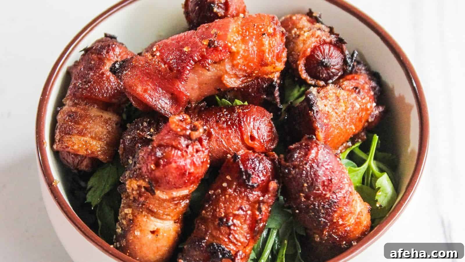 A bowl of bacon-wrapped cocktail sausages served on a bed of fresh green herbs.