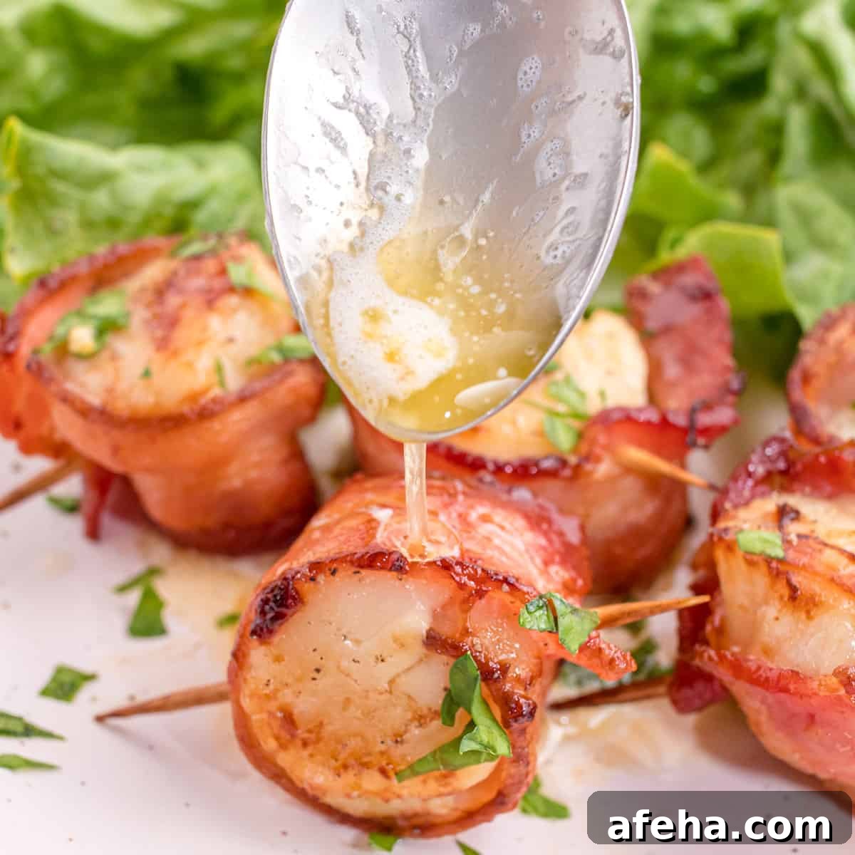 Melted butter being drizzled over air fried bacon wrapped scallops.