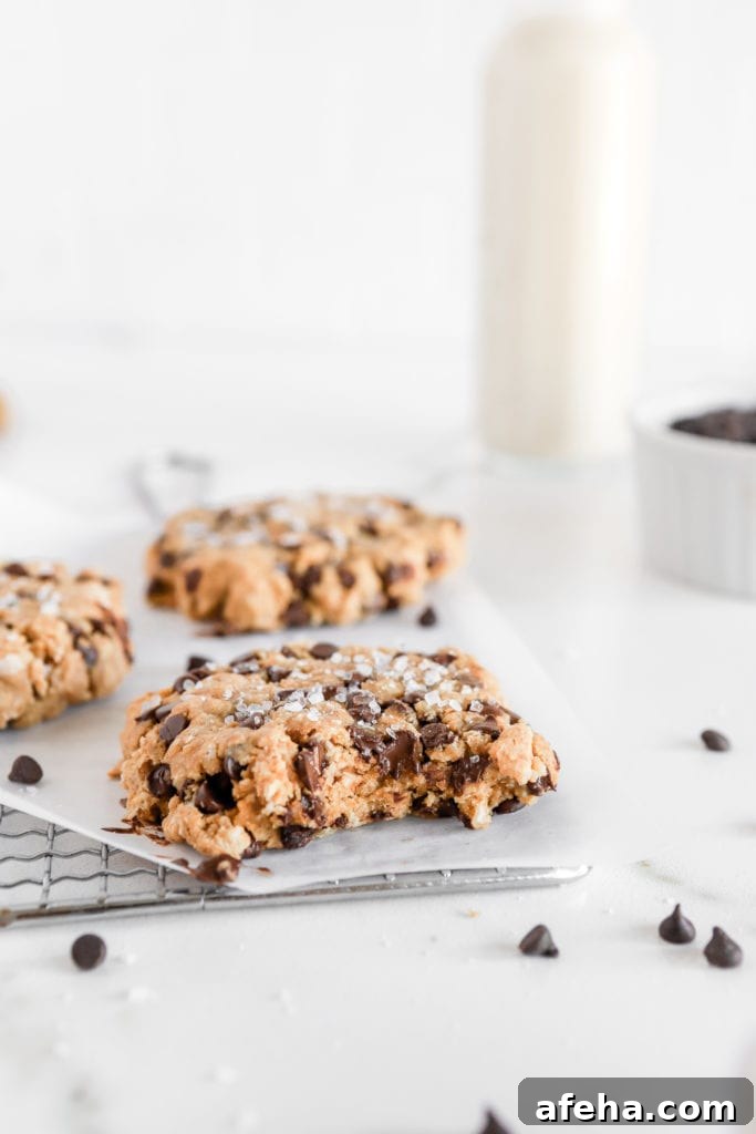 Gluten free oatmeal chocolate chip cookies with a glass of milk and flakey sea salt