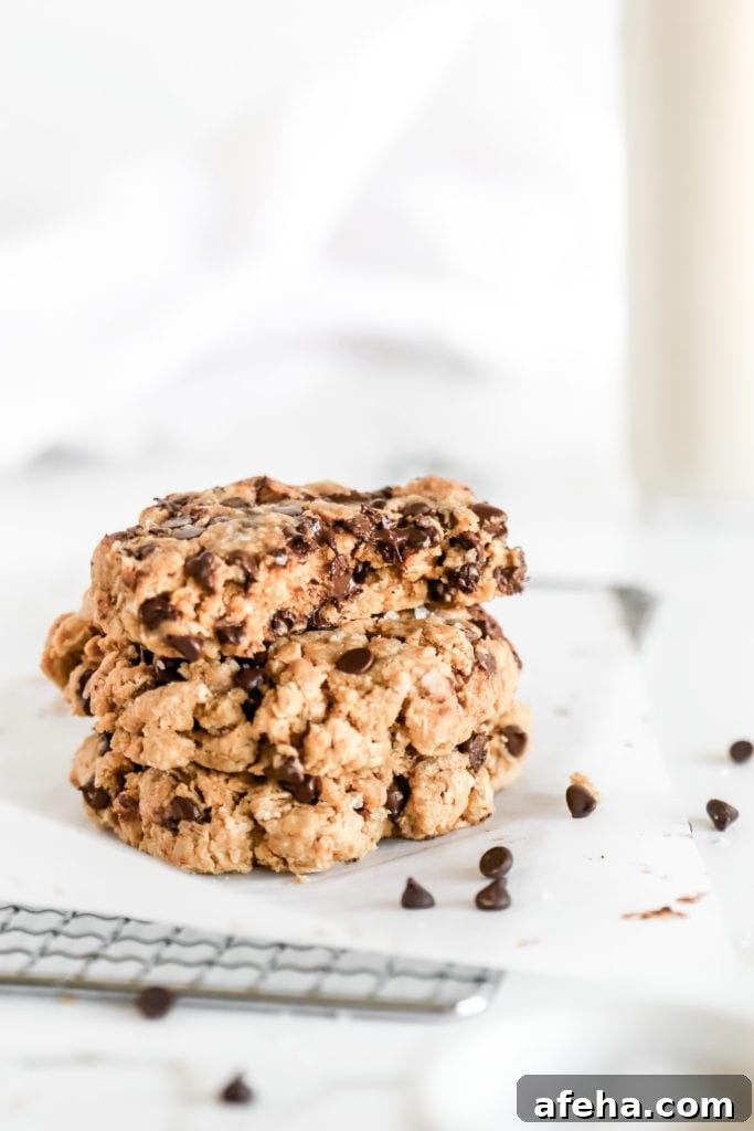 the best ever gluten free protein chocolate chip cookies stacked on top of each other with mini dark chocolate chip in the fore ground