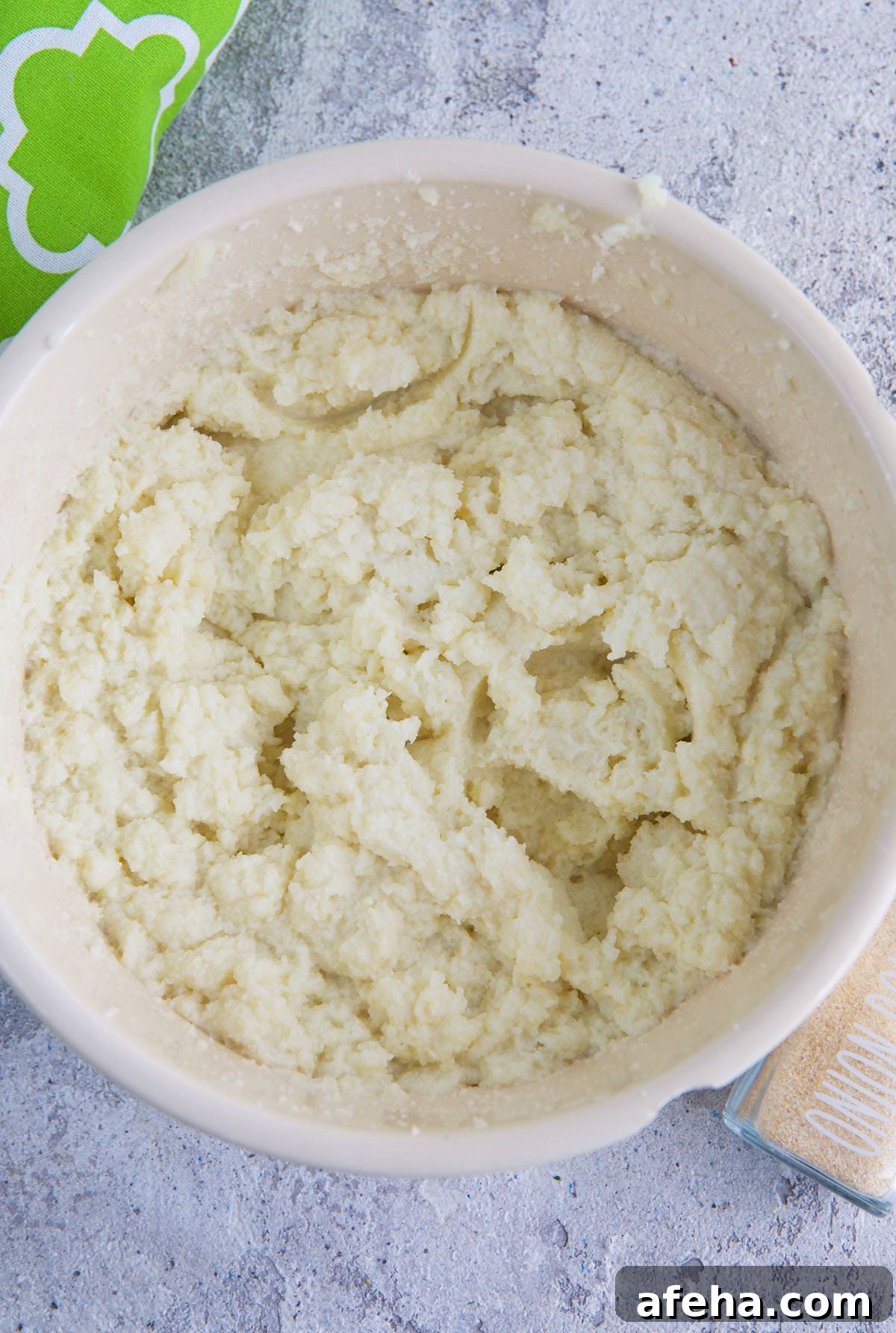 A bowl is filled with mashed cauliflower. 