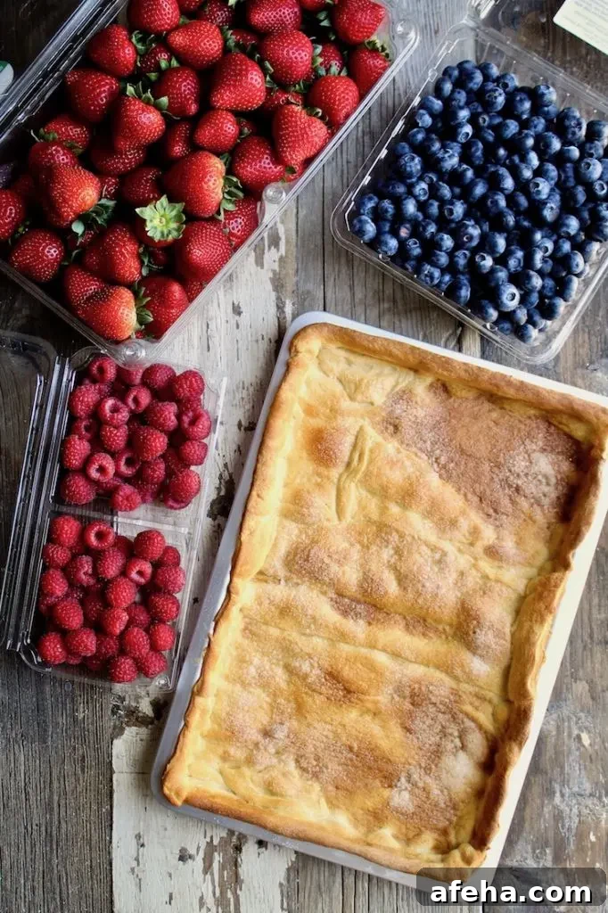 Red, White & Blue Fruit Pizza ingredients, fresh berries and crust in pan.