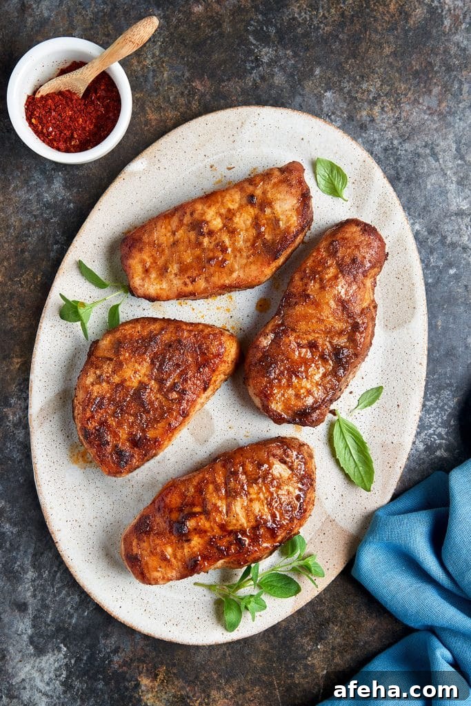 Golden brown air fried pork chops on a plate