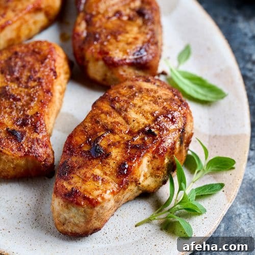 Thick golden brown air fried pork chops on a plate