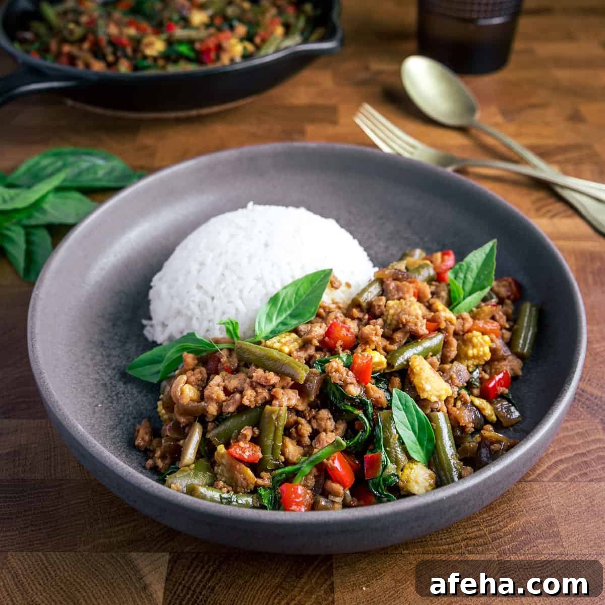 Vegan San Choy Bau Recipe: Flavorful Plant-Based Lettuce Wraps 16 Photo of thai basil vegan stir fry with white rice in a dark grey bowl