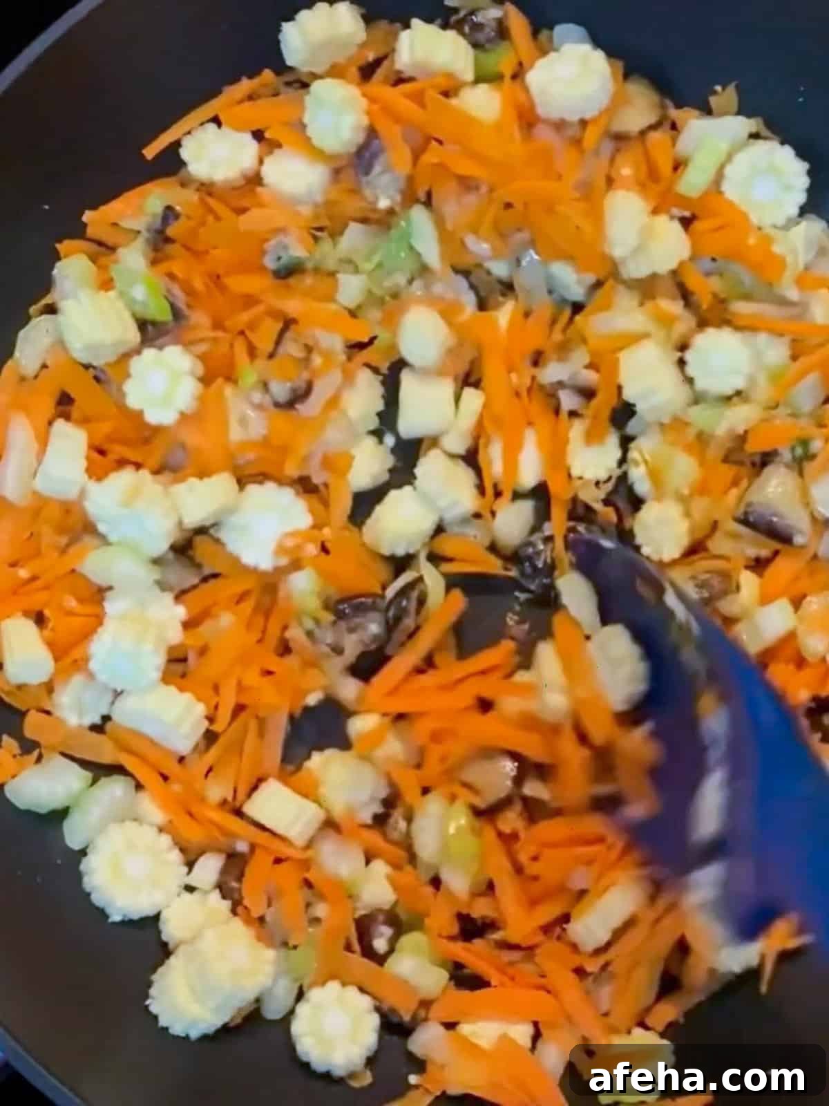Vegan San Choy Bau Recipe: Flavorful Plant-Based Lettuce Wraps 7 Photo of stir-frying vegan san choy bau after carrot, baby corn and celery added.