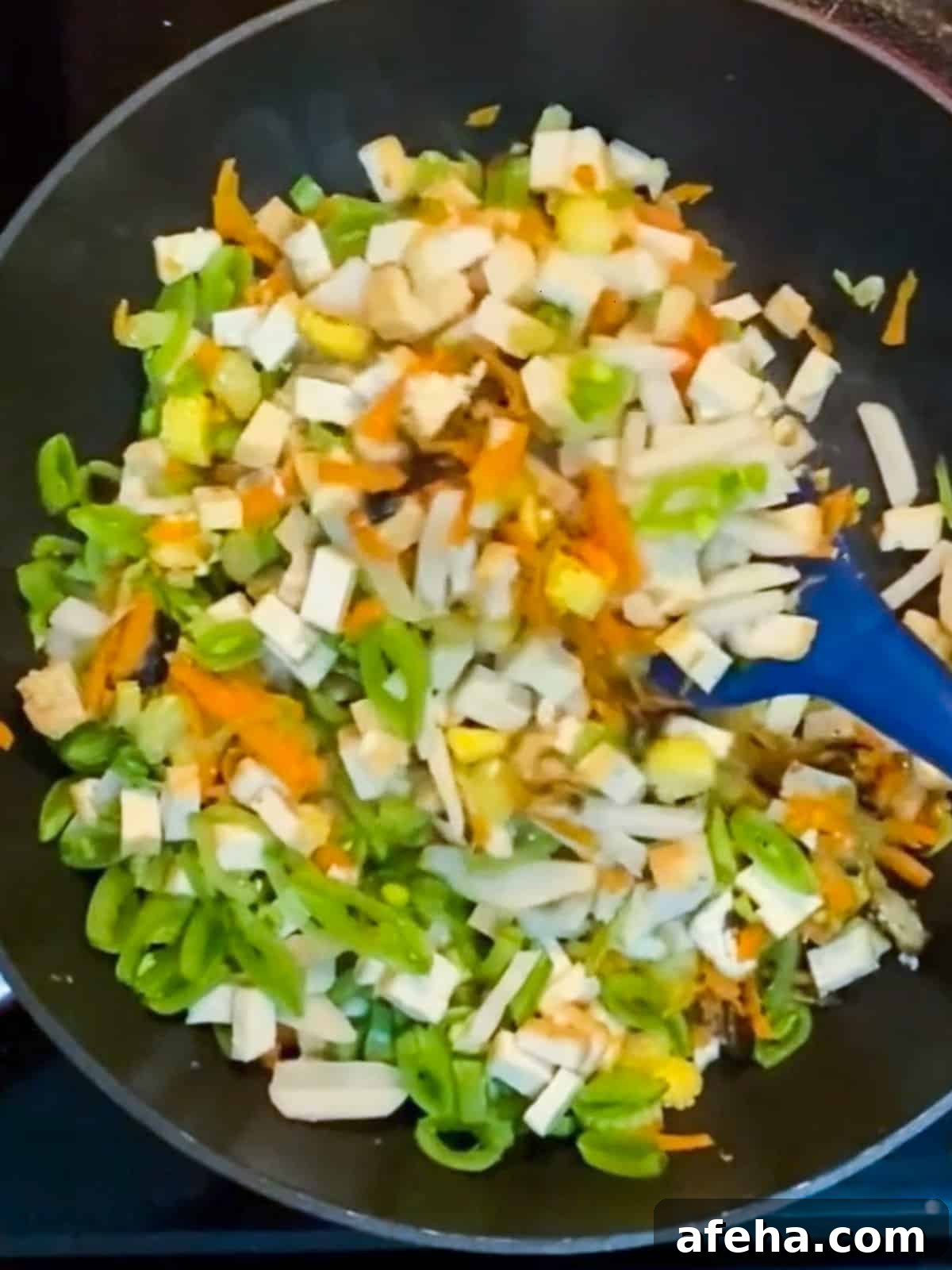 Vegan San Choy Bau Recipe: Flavorful Plant-Based Lettuce Wraps 8 Photo of stir-frying vegan san choy bau after tofu and water chestnuts added.