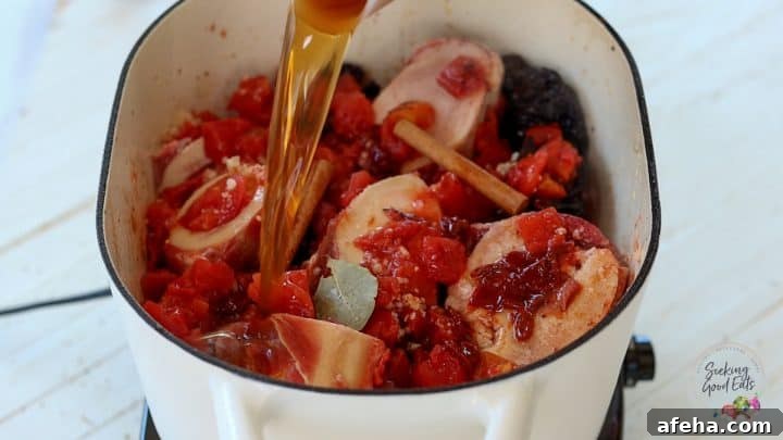 Birria Tacos with Rich Consommé: Where to Eat and How to Make Them 6 Adding the remaining birria taco ingredients to the pot.
