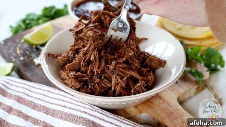 Birria Tacos with Rich Consommé: Where to Eat and How to Make Them 7 Shredding the birria taco meat