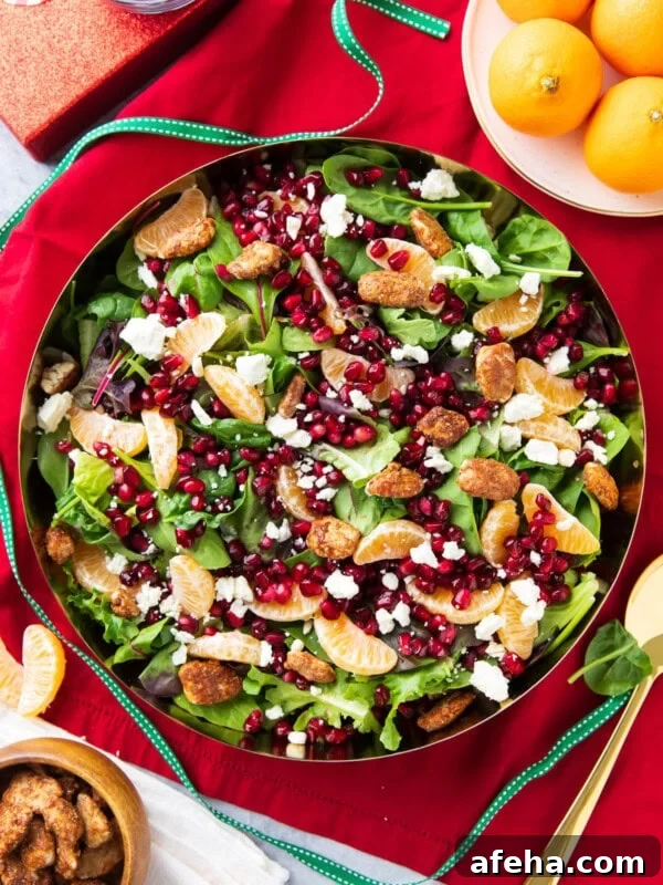 Christmas Salad packed full of baby lettuce, arugula, spinach, oranges, nuts, and cheese