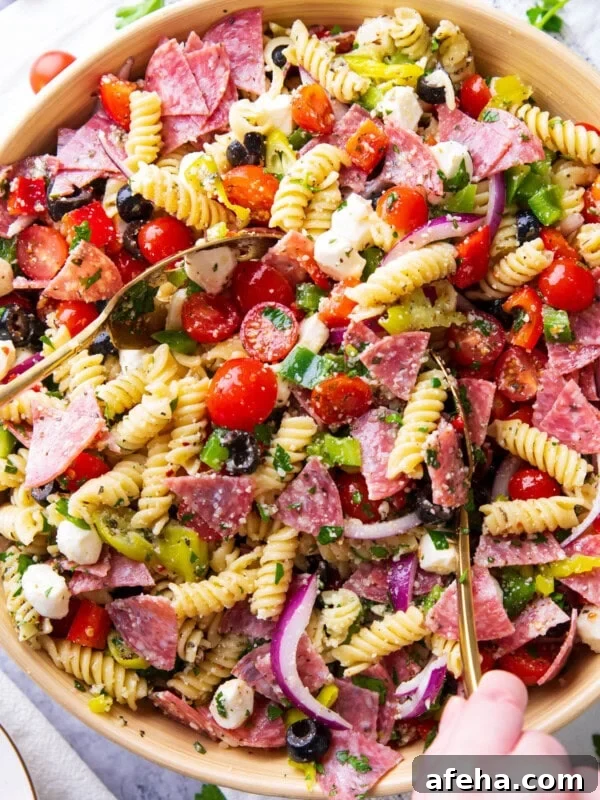 A large serving bowl filled with Italian pasta salad
