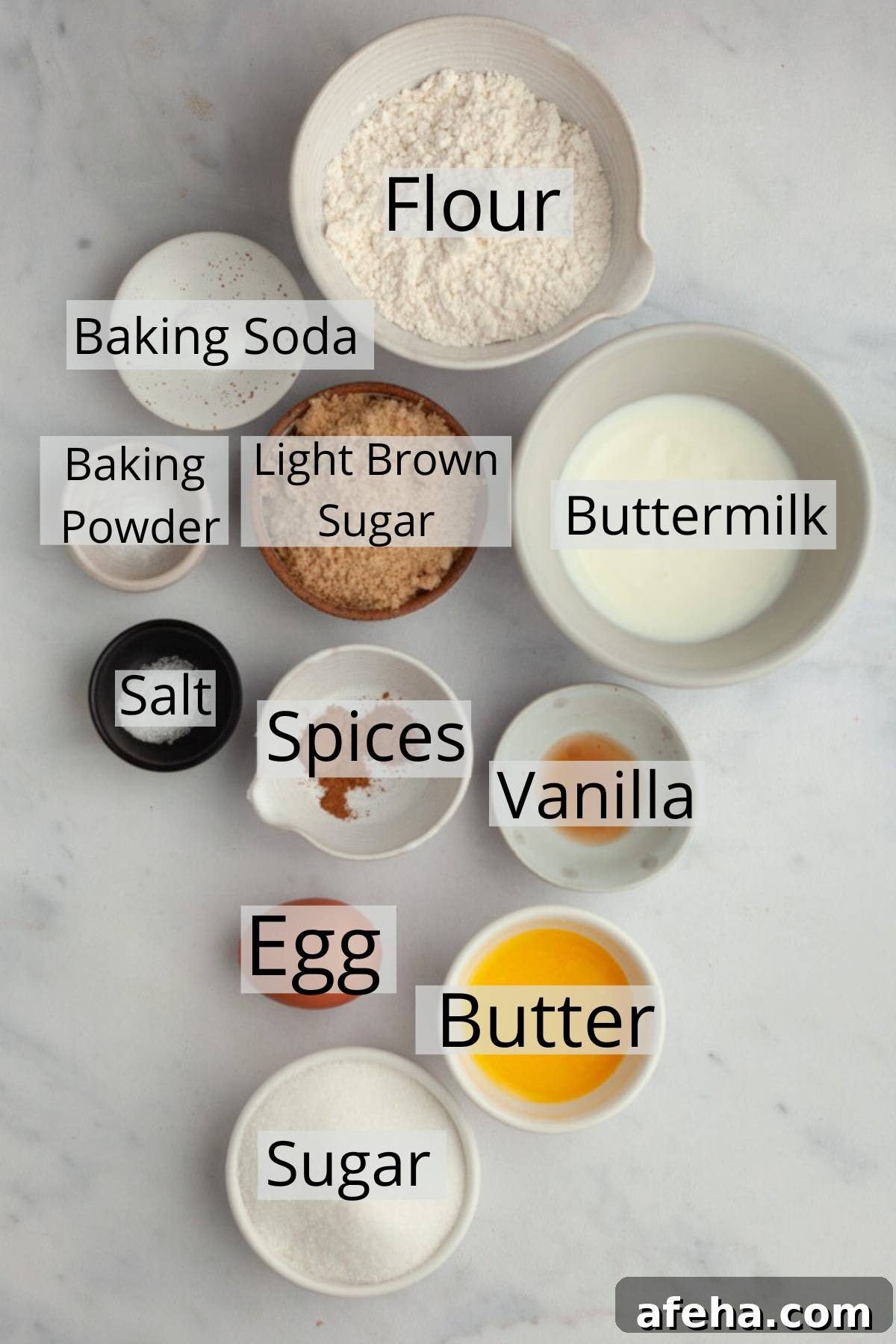 All the ingredients needed to make cinnamon donuts, weighed out into small bowls.