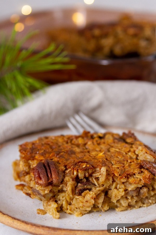 a slice of baked oatmeal in front of the casserole dish of oatmeal and some pine neddles next to it.