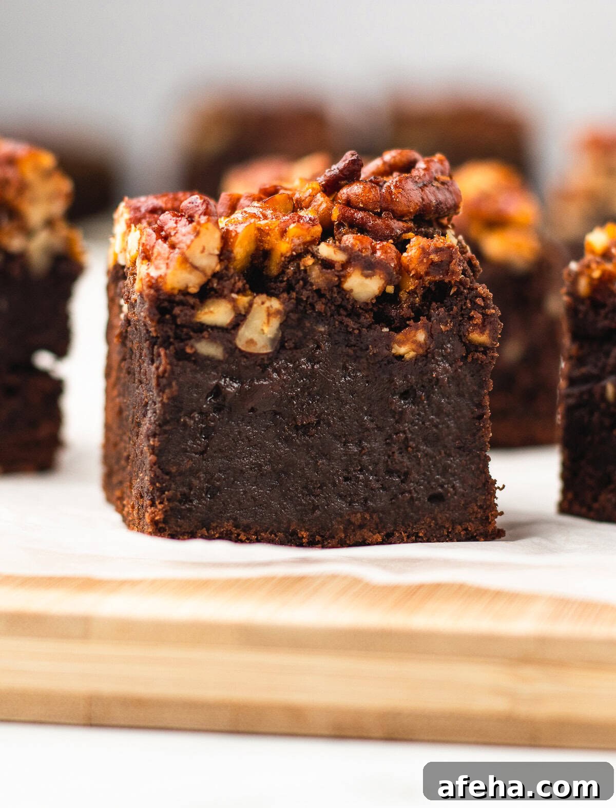 Homemade Pecan Pie Brownies Recipe — From Scratch and Rich 7 close up image of one Pecan Pie Brownies on parchment paper