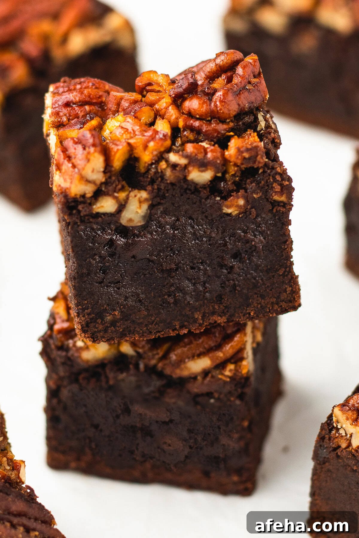 Homemade Pecan Pie Brownies Recipe — From Scratch and Rich 8 up close image of two Pecan Pie Brownies stacked on top of each other